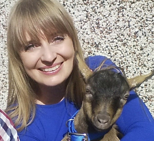 Emma at home with one of her pygmy goats